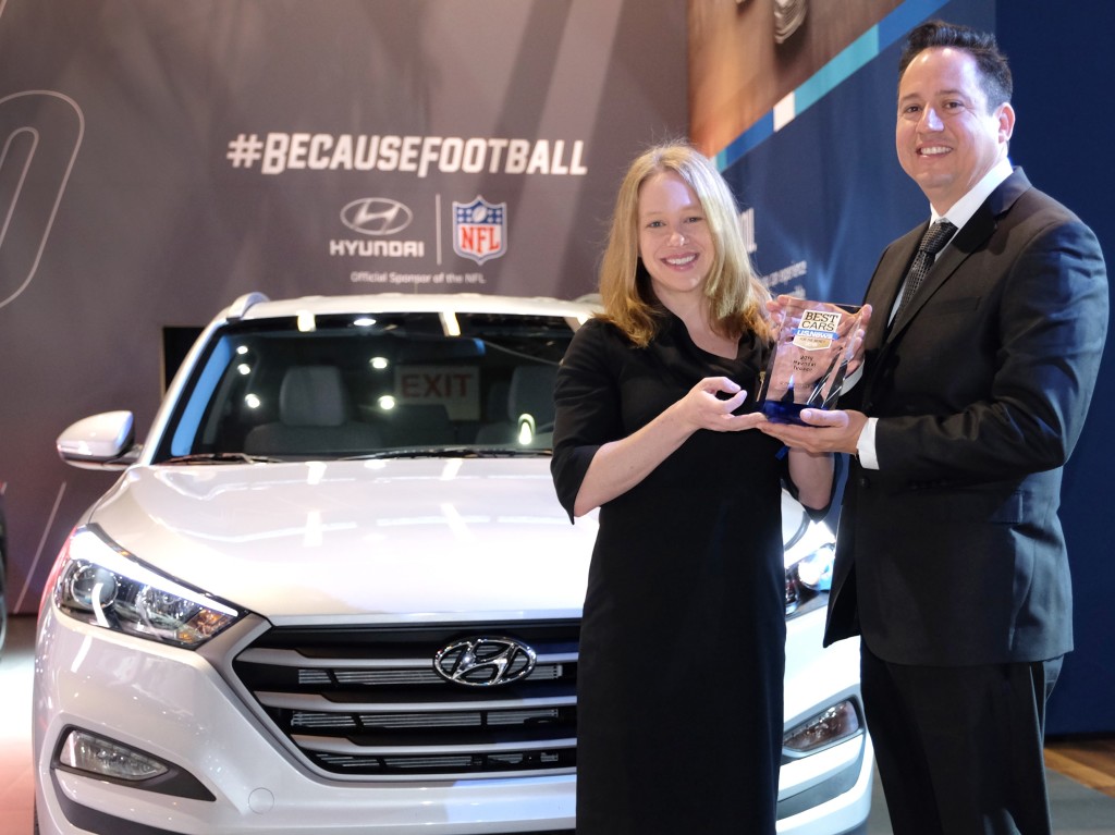 Left to Right: Jamie Page Deaton, managing editor of the U.S. News Best Car rankings, presents Brandon Ramirez, senior group manager, product planning, Hyundai Motor America, the trophy for the 2016 Hyundai Tucson as the Best Compact SUV for the Money by U.S. News & World Report at the 2016 Chicago Auto Show.